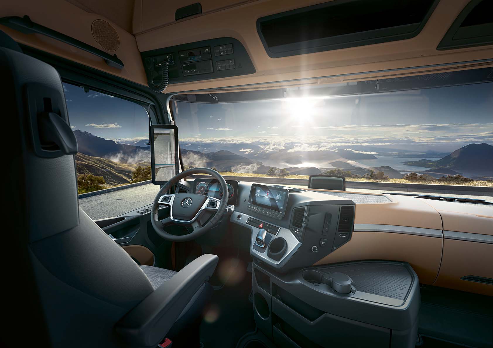 Blick von der Rückbank des LKW-Führerhauses auf eine sonnige Berglandschaft